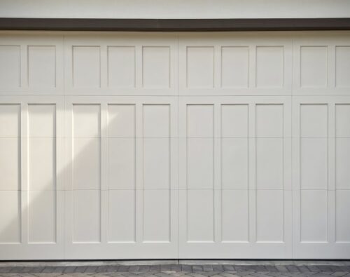 A clean and white garage door in a residential area after the renovation