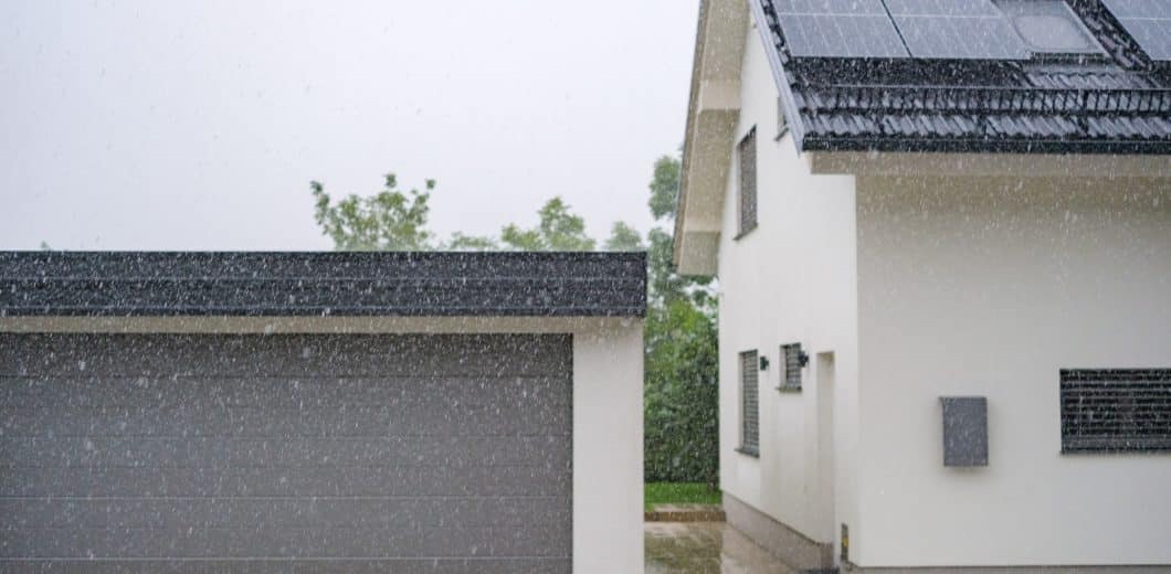 house with garage door while raining
