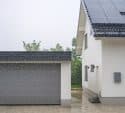 house with garage door while raining