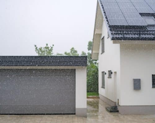 house with garage door while raining
