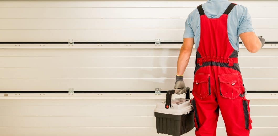professional inspecting garage door