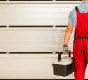 professional inspecting garage door