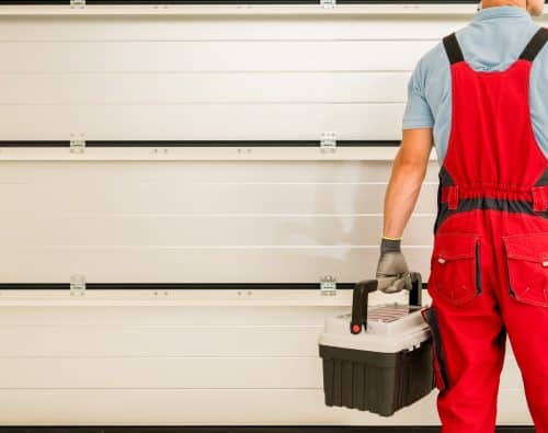 professional inspecting garage door