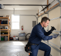 residential garage with a professional technician performing a detailed inspection