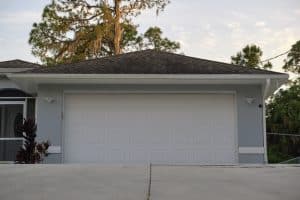 Wide garage double door and concrete driveway of new modern american house.