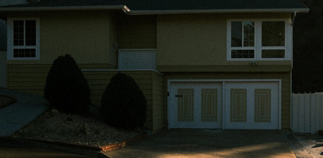 Suburban house with a garage and manicured bushes
