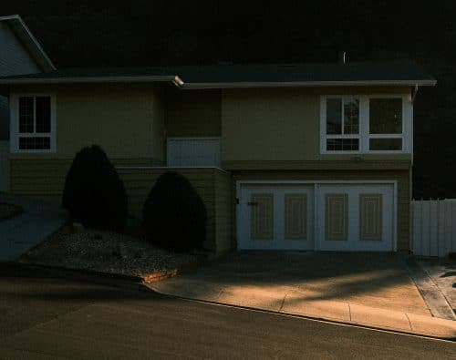 Suburban house with a garage and manicured bushes