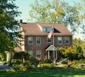 Brick house with a flag in front