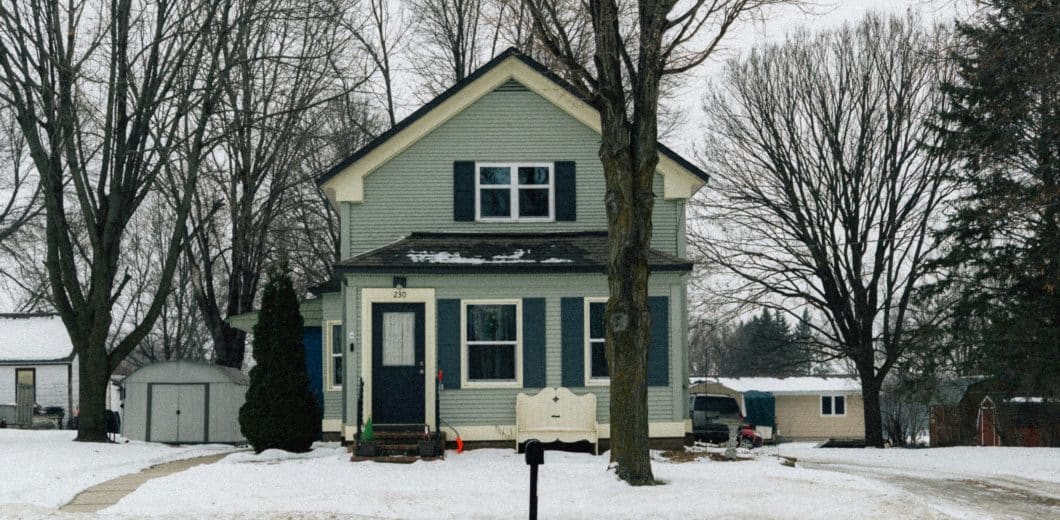 Light blue house in a snowy landscape