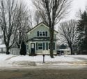 Light blue house in a snowy landscape