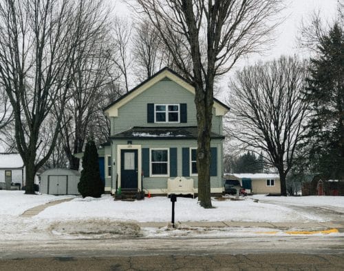 Light blue house in a snowy landscape
