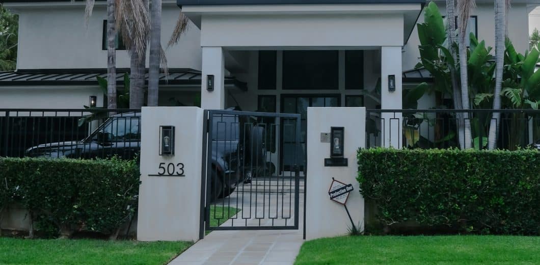 Modern house with manicured hedges and gate