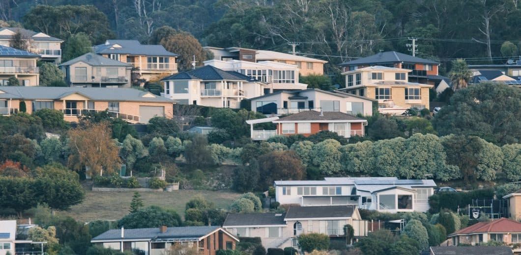 Houses built on a tree-covered hillside