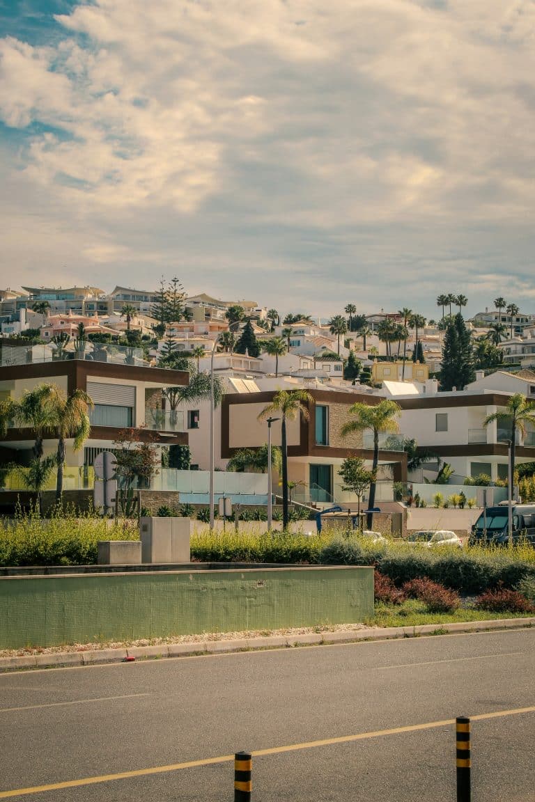 Modern houses on a hillside under a cloudy sky