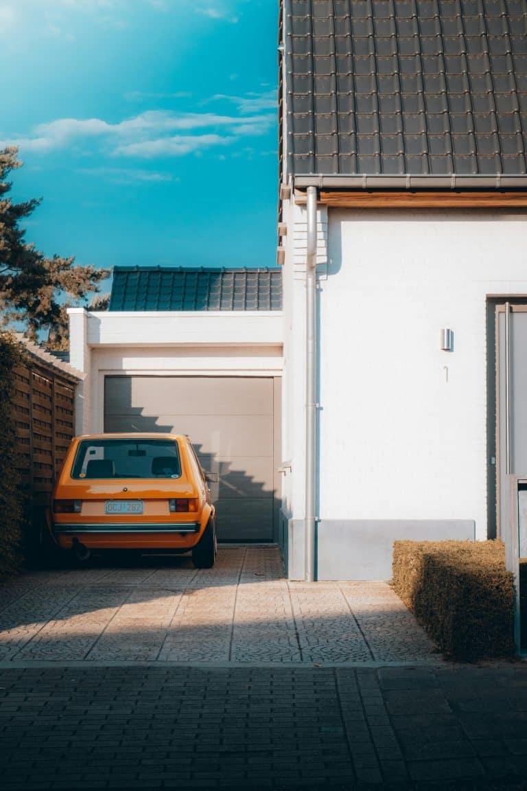 Car parked beside a white building