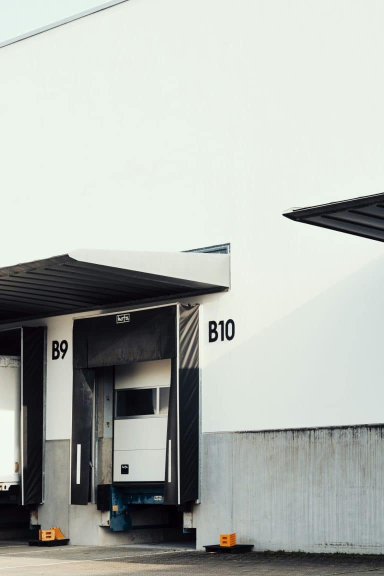 White industrial building with loading docks