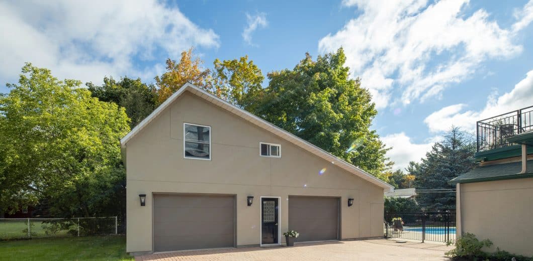 Family home exterior with garage and backyard pool