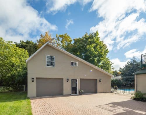 Family home exterior with garage and backyard pool