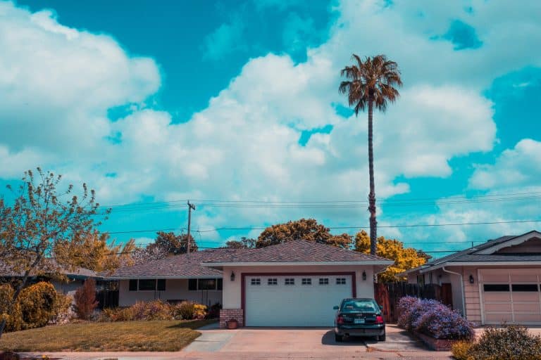 White and gray house with a closed garage door