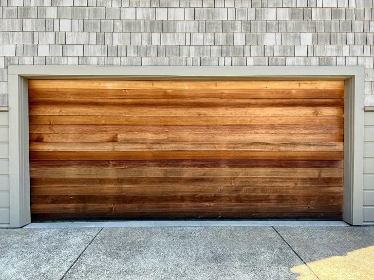 Wooden garage door on a brick home