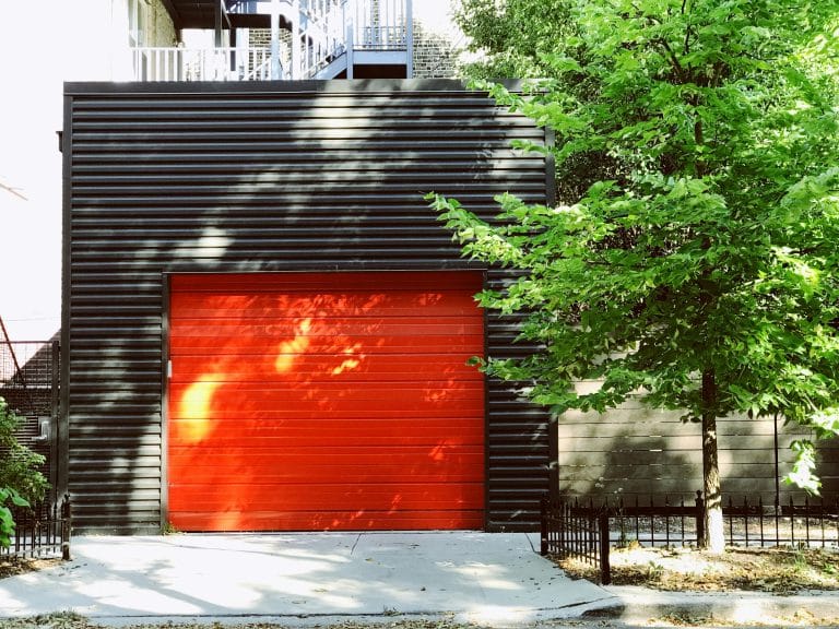 Red garage door shutter on a home exterior