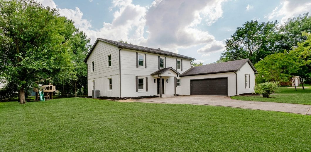 White two-story house with a garage