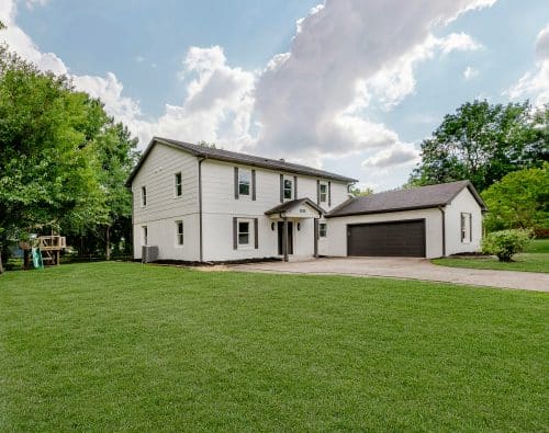 White two-story house with a garage