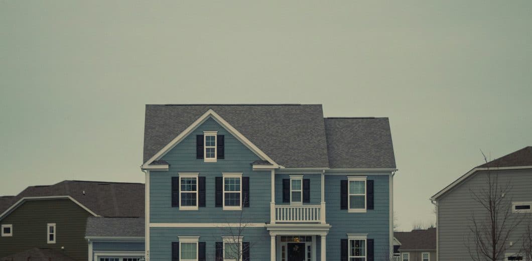 Blue two-story house with black shutters