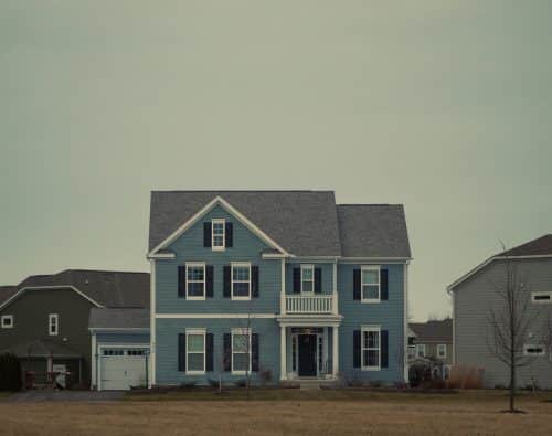 Blue two-story house with black shutters