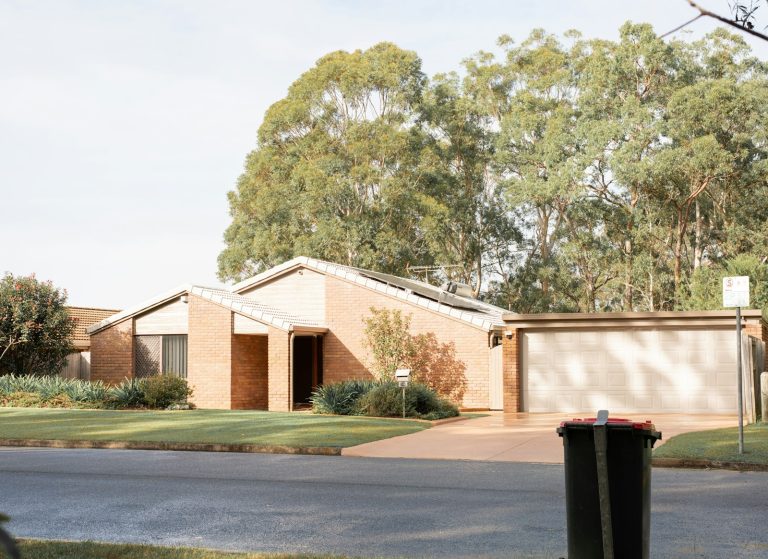 Brick home with a wide garage door and tidy front yard