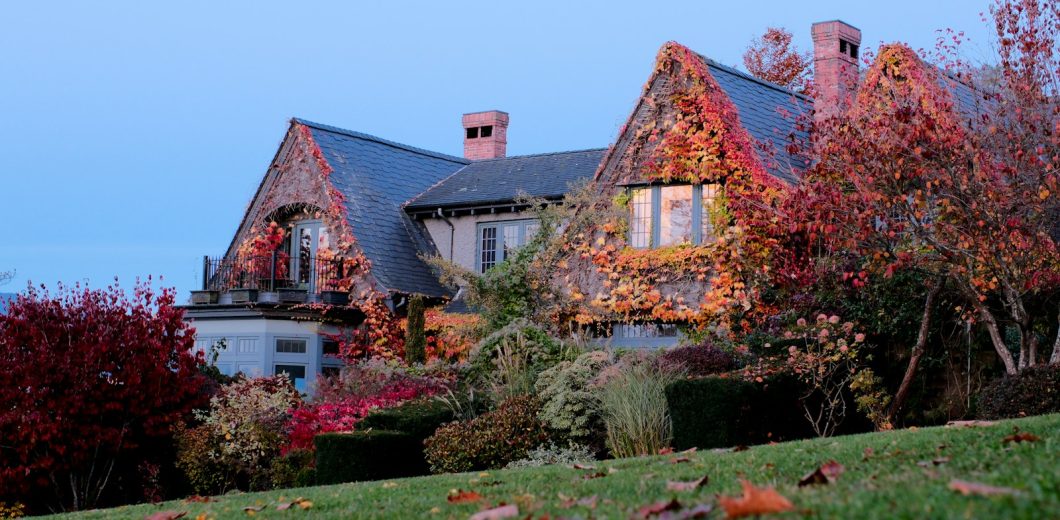 Home covered in bright fall foliage as the season turns cold
