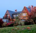 Home covered in bright fall foliage as the season turns cold