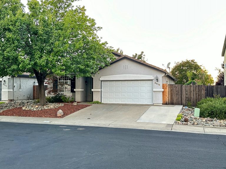 Suburban home with a white garage door awaiting inspection