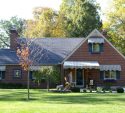 Tidy brick home with early fall color in the front yard