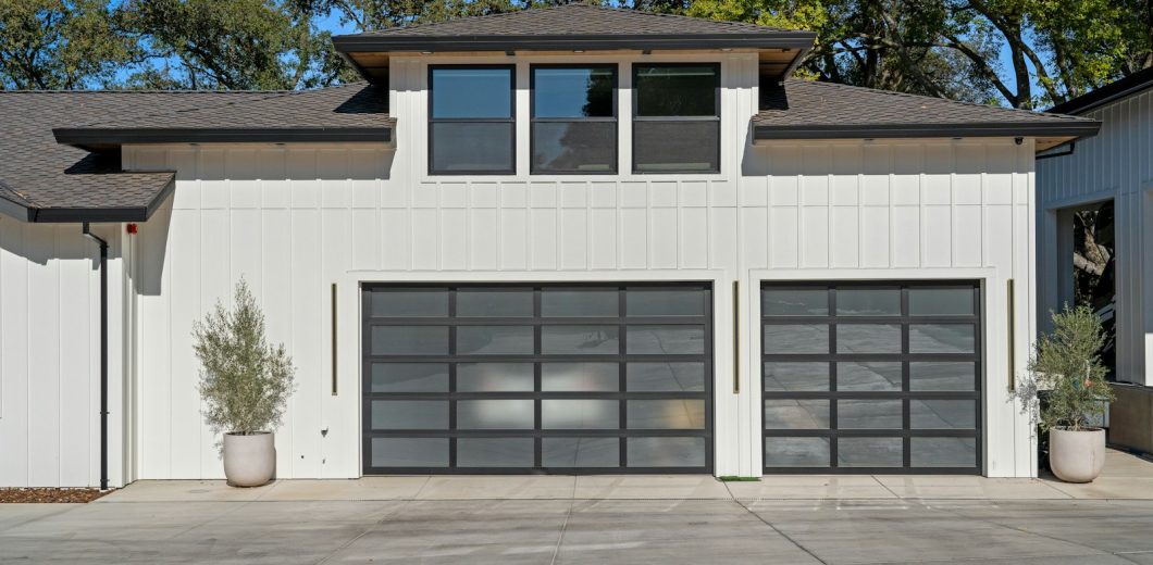Modern home with two glass panel garage doors ready for fall in Lakewood, CO