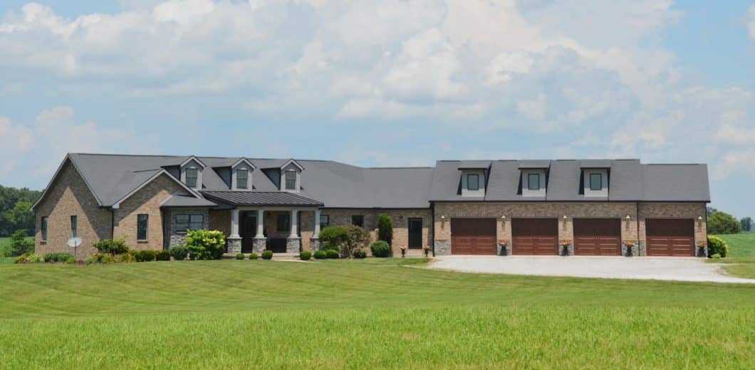 Home with multiple garage doors on a large property