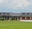 Home with multiple garage doors on a large property