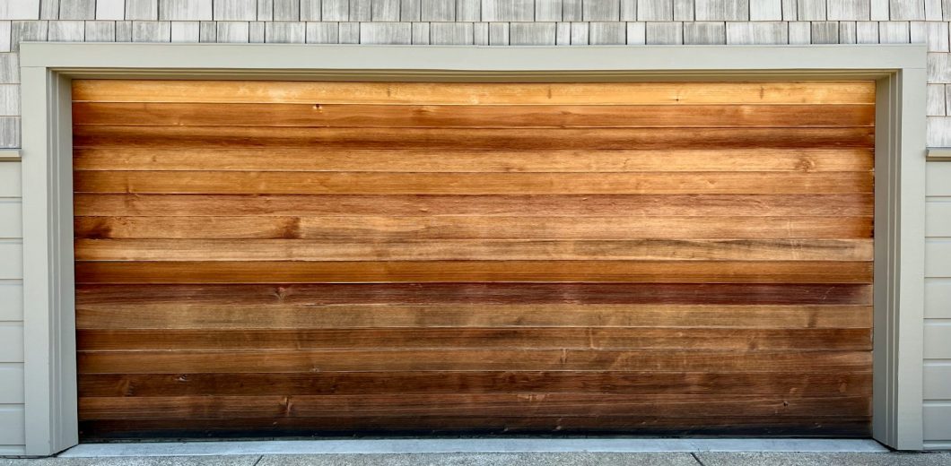 Wood panel garage door on a well kept home in Lakewood, CO