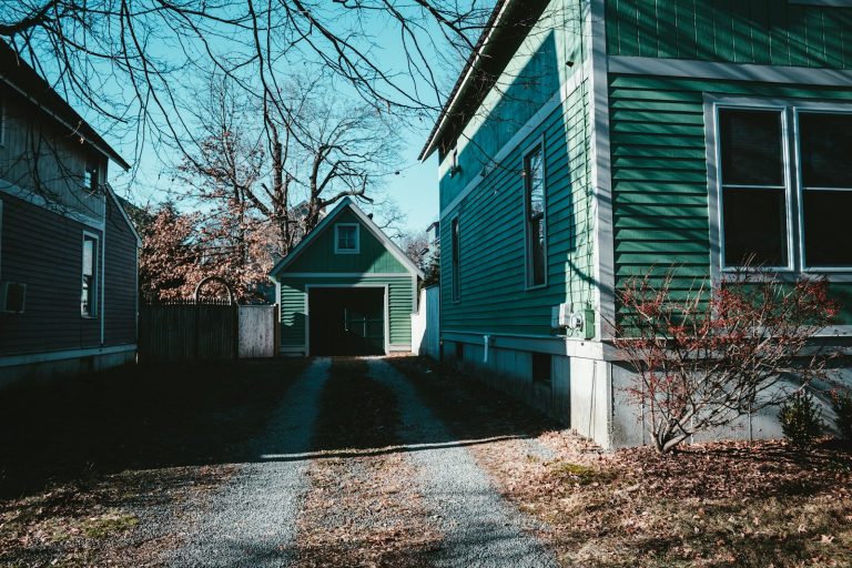 Home and detached garage among bare late fall trees
