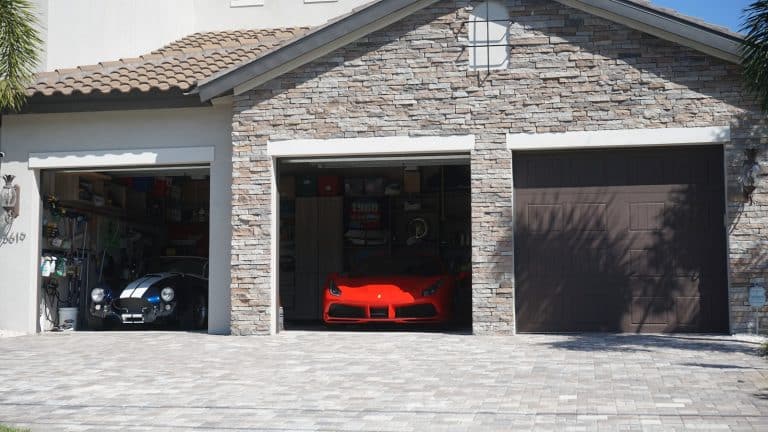Two open garage bays with vehicles parked inside